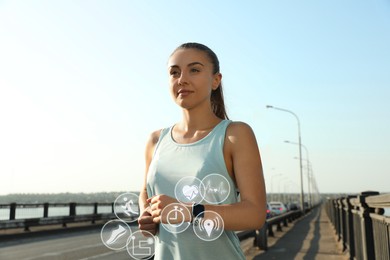 Woman with modern smart watch during training outdoors. Icons near device