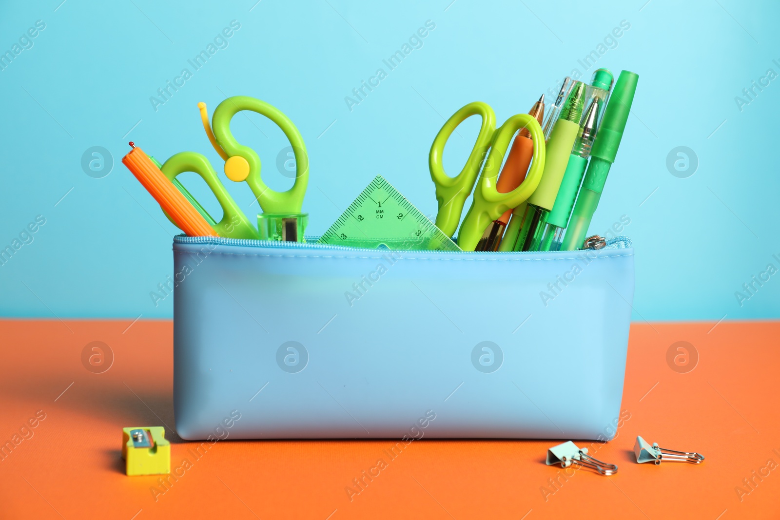 Photo of Pencil case with different stationery on color background