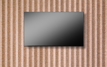 Image of Tv set with flat screen mounted on wall