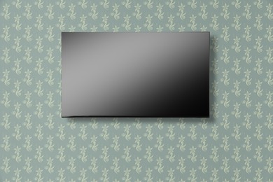 Image of Tv set with flat screen mounted on wall