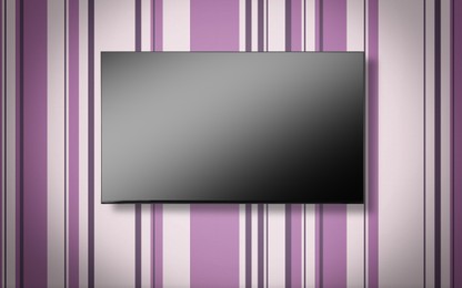 Image of Tv set with flat screen mounted on wall