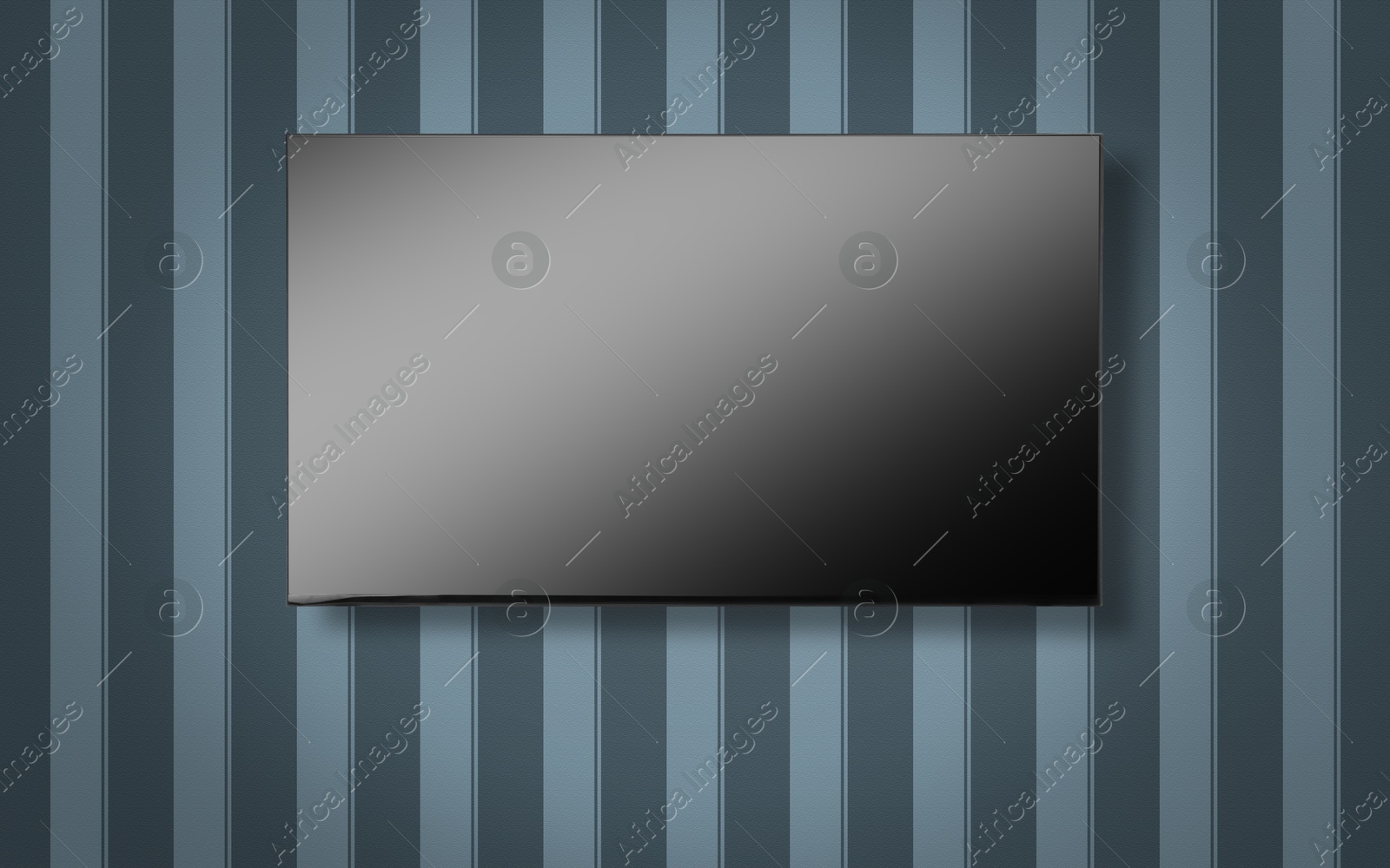 Image of Tv set with flat screen mounted on wall