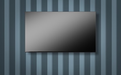 Image of Tv set with flat screen mounted on wall