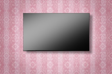 Image of Tv set with flat screen mounted on wall