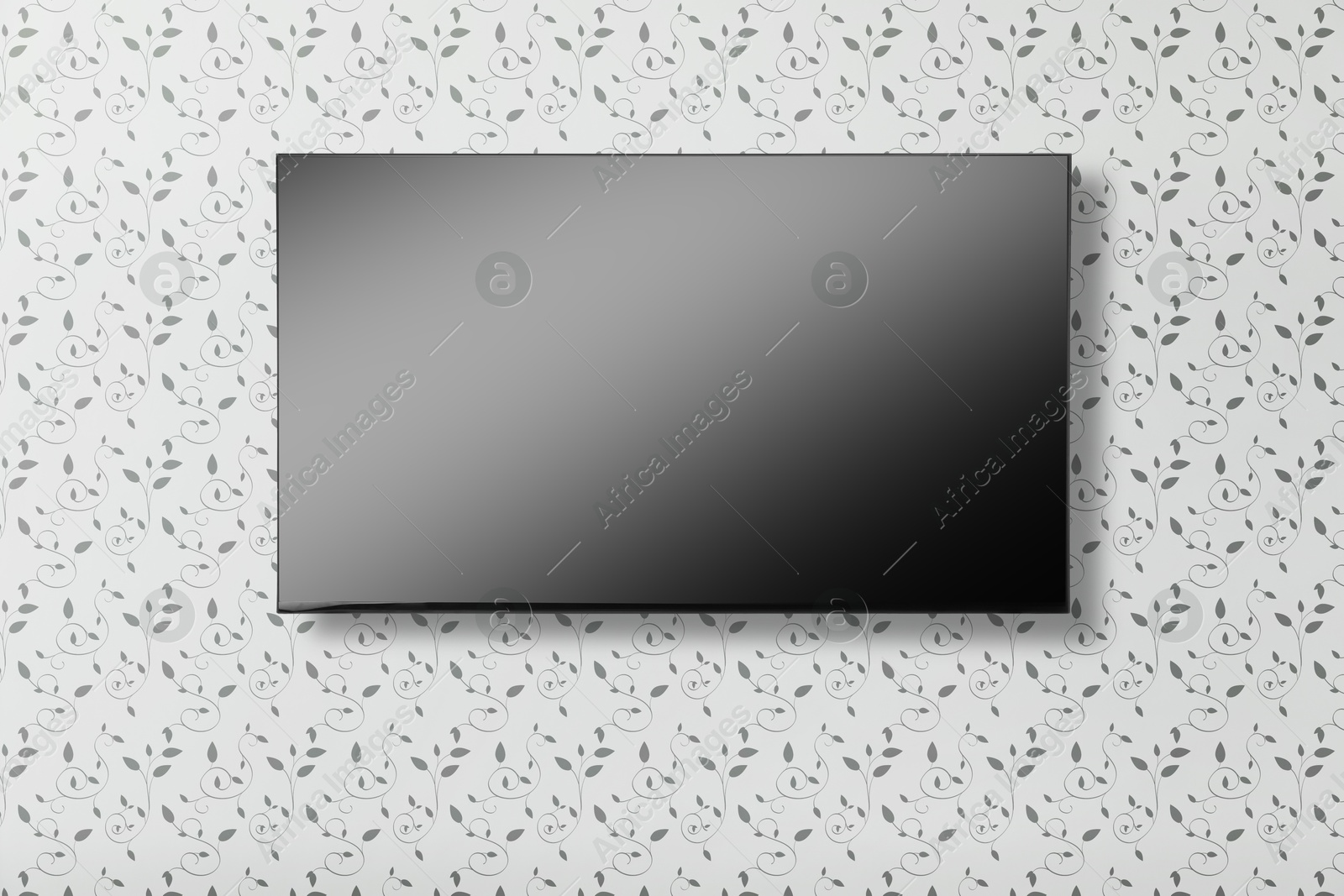 Image of Tv set with flat screen mounted on wall