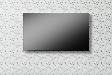 Image of Tv set with flat screen mounted on wall