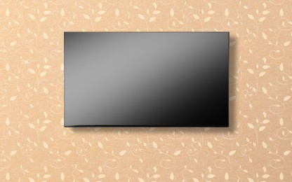 Image of Tv set with flat screen mounted on wall