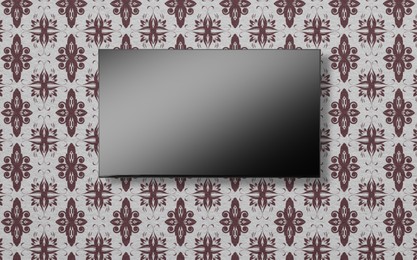 Image of Tv set with flat screen mounted on wall