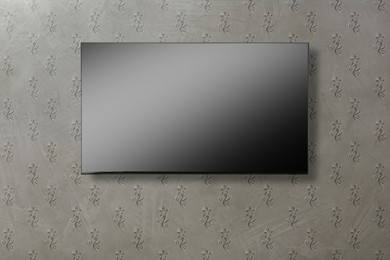 Image of Tv set with flat screen mounted on wall