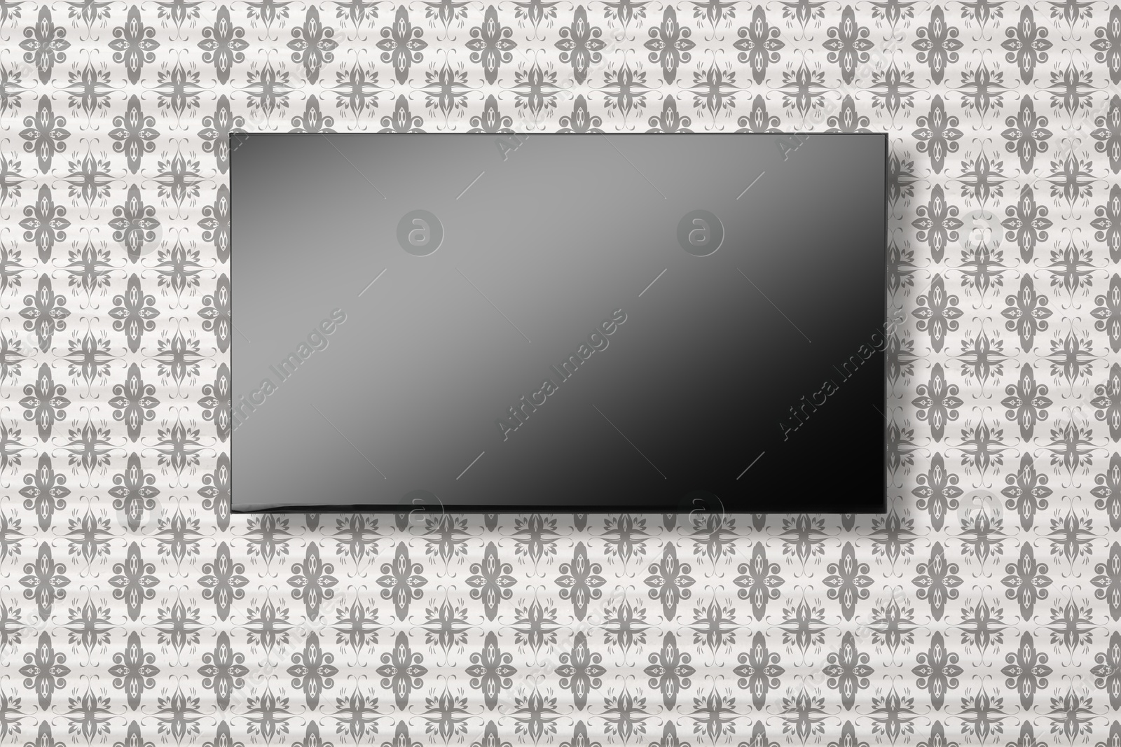 Image of Tv set with flat screen mounted on wall