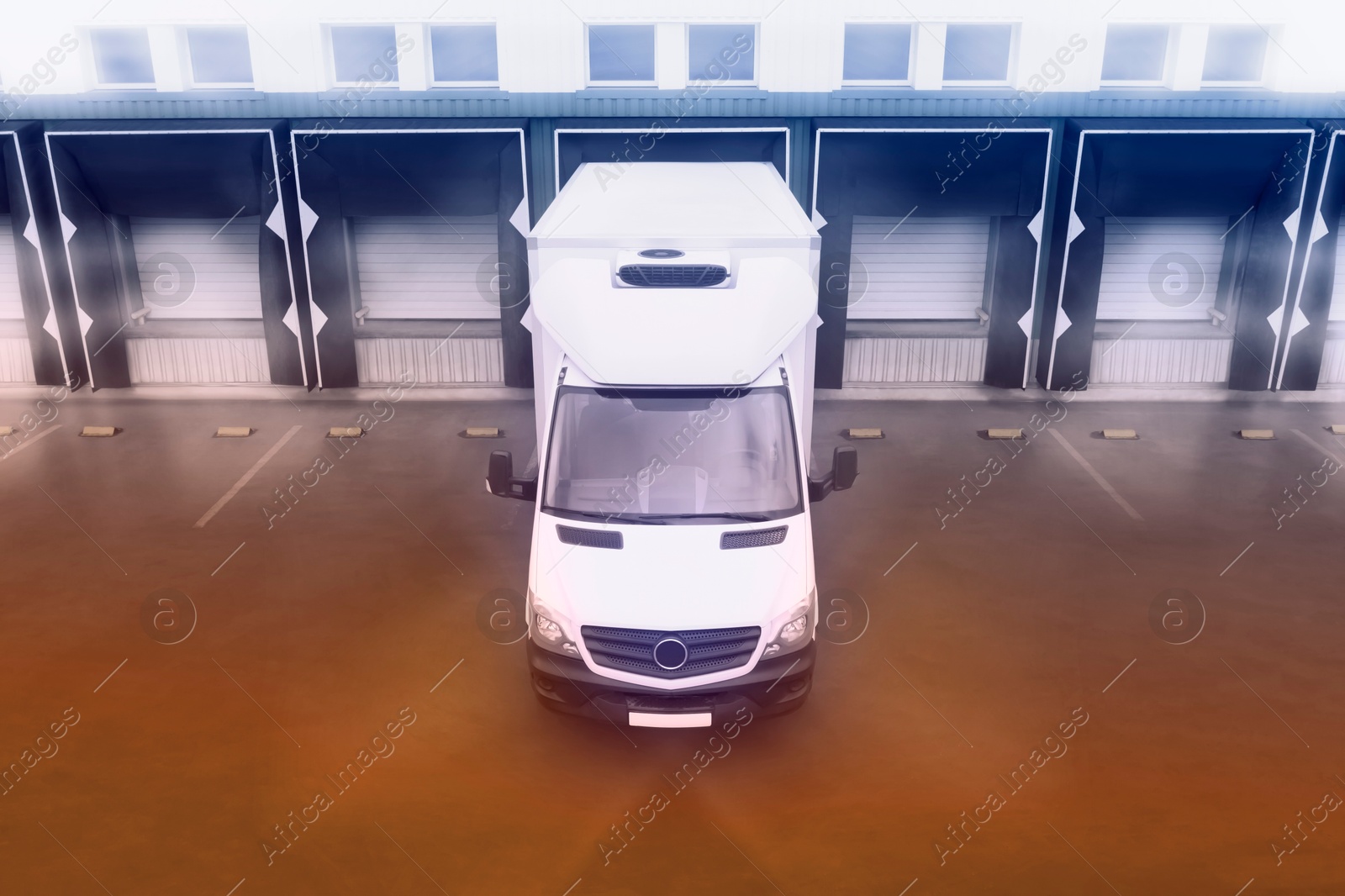 Image of Truck near loading dock of warehouse outdoors, color toned. Logistics center