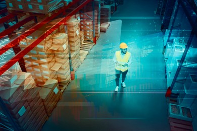 Man with tablet working at warehouse, above view. Logistics center