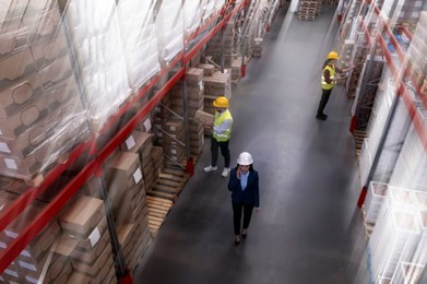 Image of Manager and workers at warehouse, above view. Logistics center