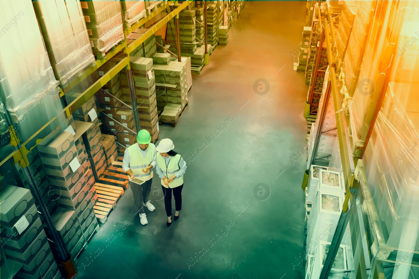 Image of Manager and worker at warehouse, above view. Logistics center. Color toned