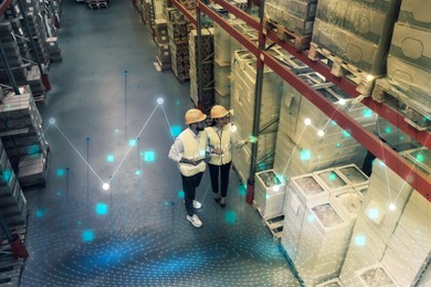 Image of Manager and worker at warehouse, above view. Logistics center. Graphs