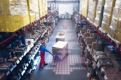 Image of Man in hardhat working with pallet truck at warehouse. Logistics center