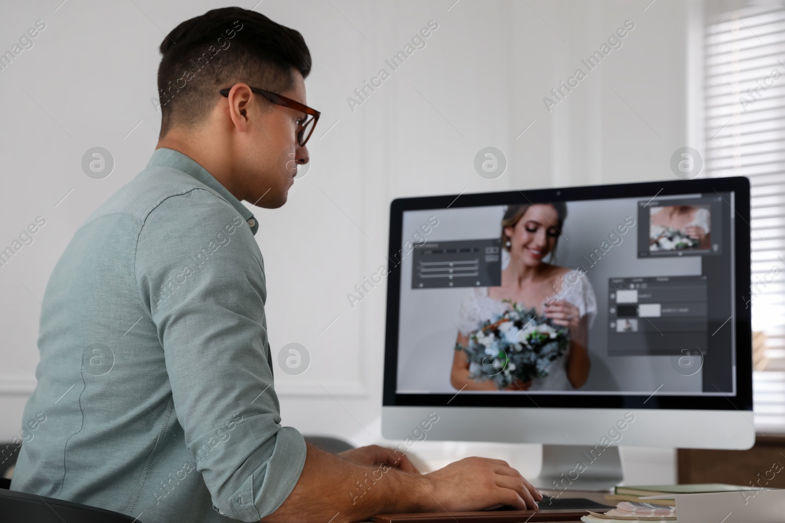 Photo of Professional retoucher working on computer in office