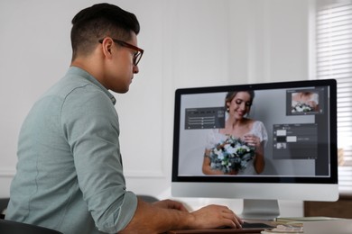 Professional retoucher working on computer in office