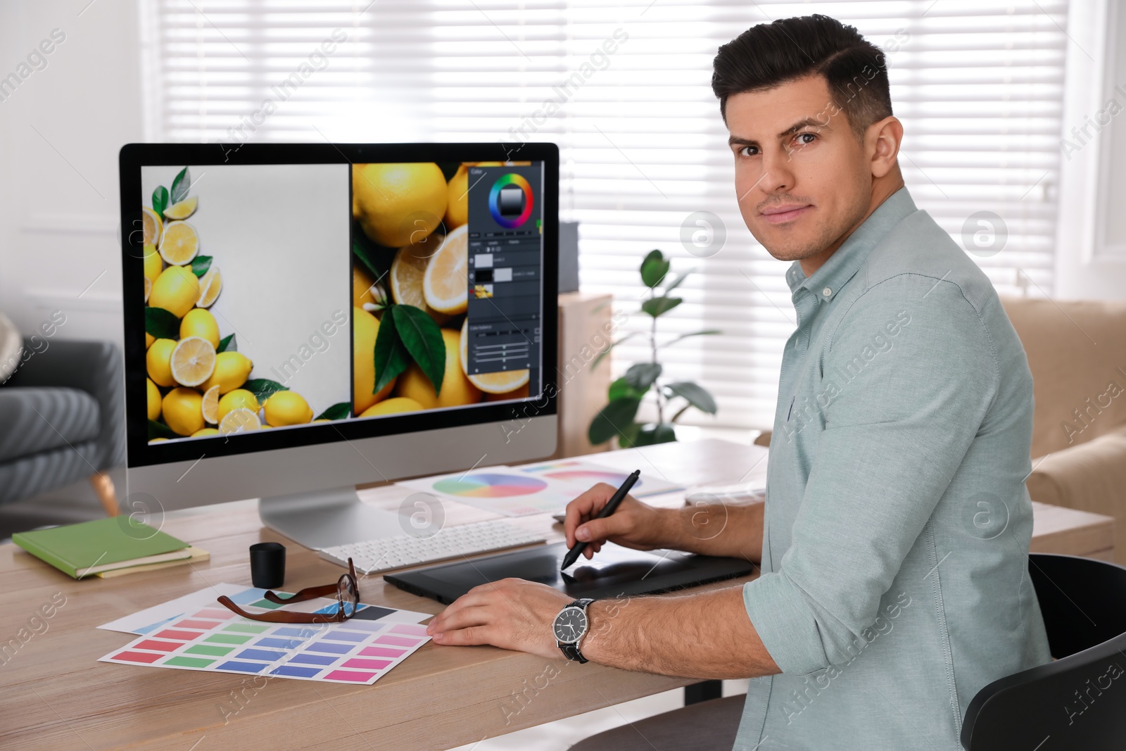 Photo of Professional retoucher working on computer in office