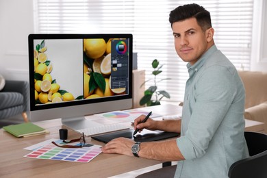 Professional retoucher working on computer in office