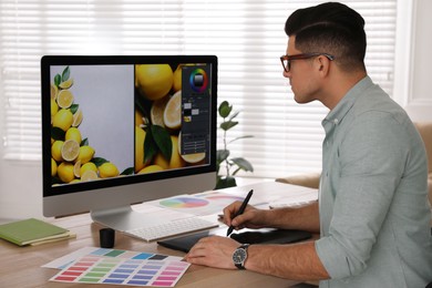 Professional retoucher working on computer in office