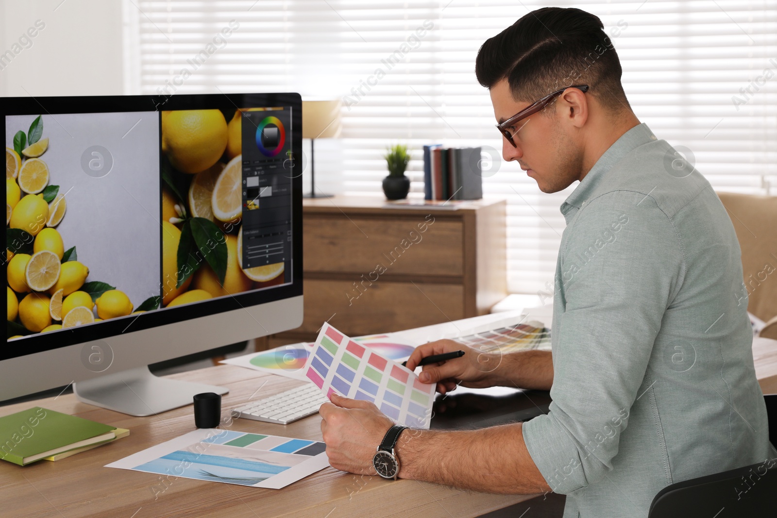 Photo of Professional retoucher working on computer in office