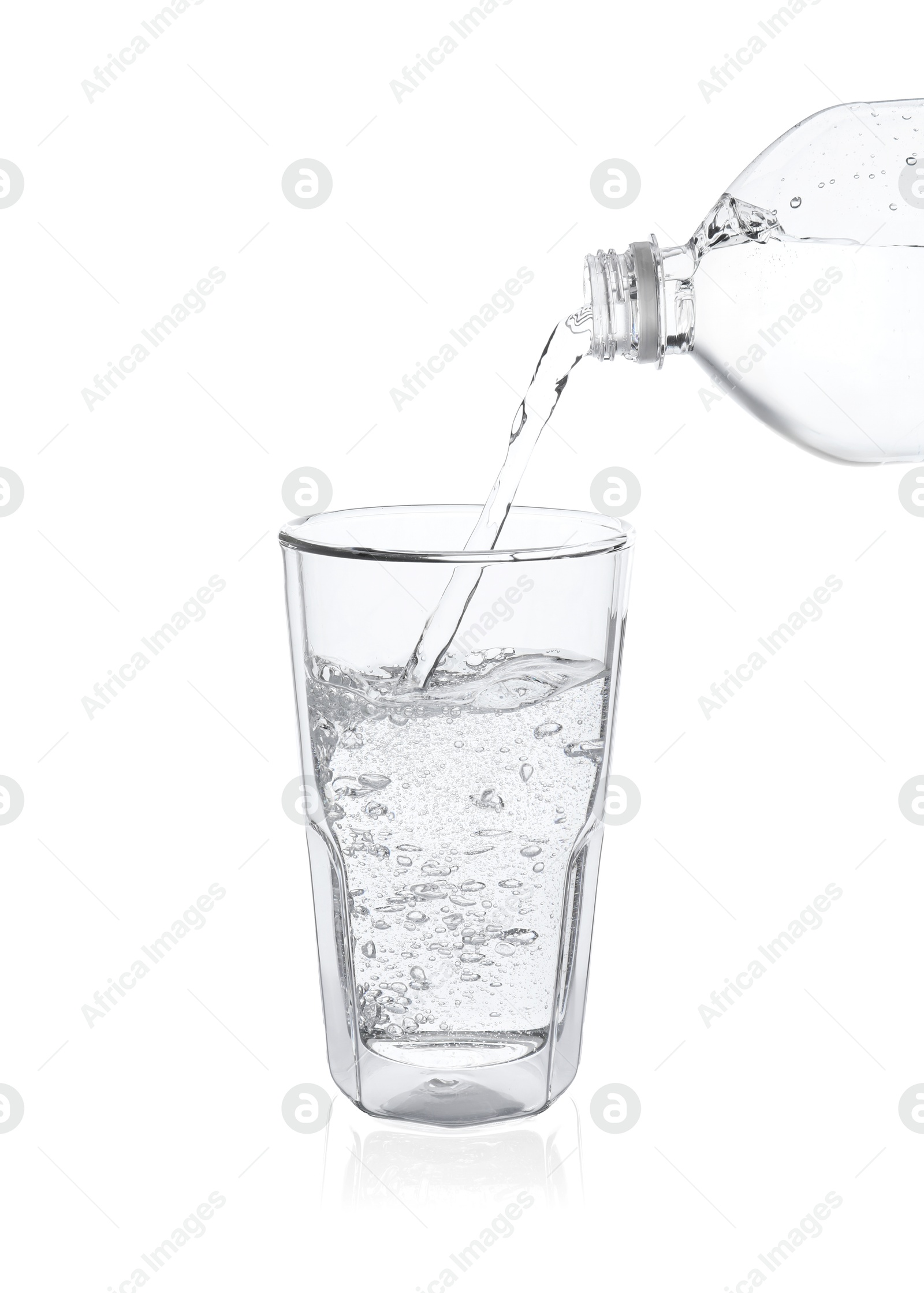 Photo of Pouring soda water from bottle into glass on white background