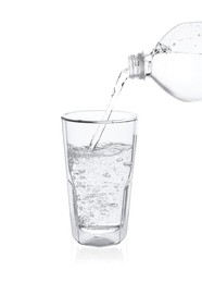 Photo of Pouring soda water from bottle into glass on white background