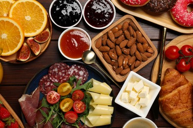 Photo of Different tasty food served for brunch on wooden table, flat lay