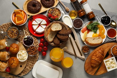 Photo of Different tasty food served for brunch on grey table, flat lay