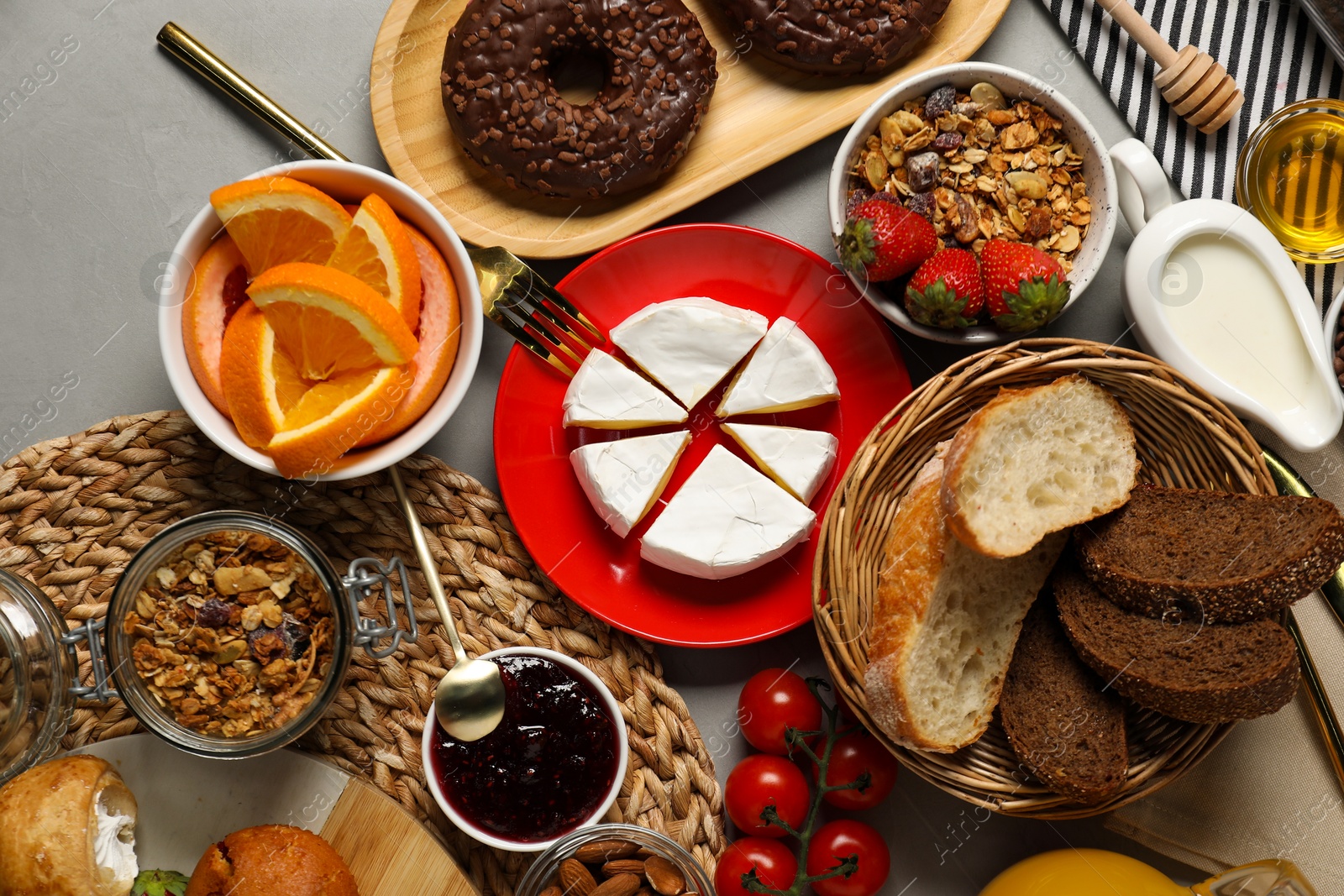 Photo of Different tasty food served for brunch on grey table, flat lay