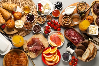 Photo of Different tasty food served for brunch on grey table, flat lay