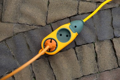 Photo of Extension cord on paved pathway outdoors, top view