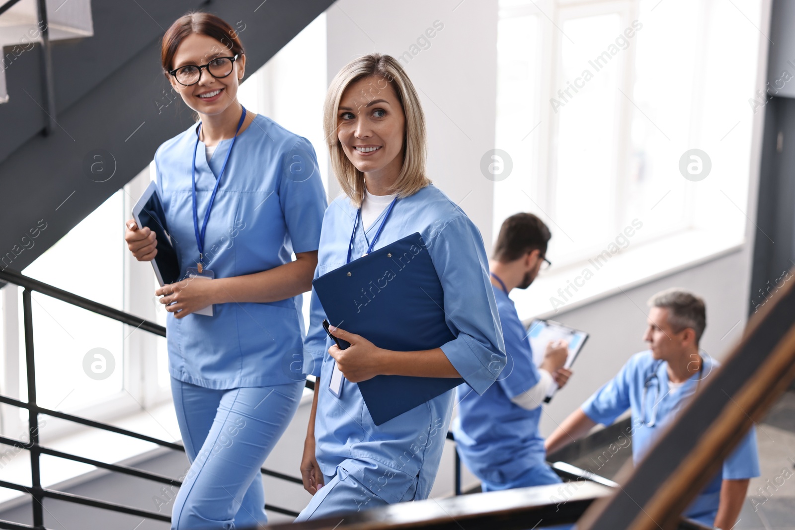 Photo of Healthcare workers with tablet and clipboard in hospital