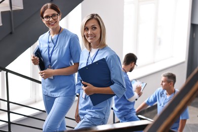 Photo of Healthcare workers with tablet and clipboard in hospital