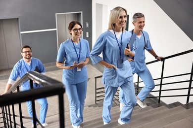 Healthcare workers walking up stairs in hospital