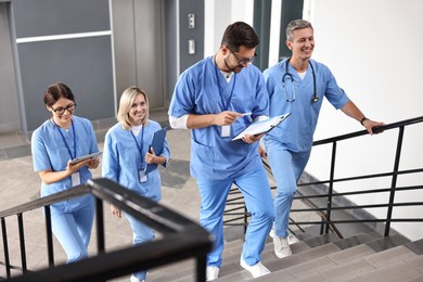 Healthcare workers walking up stairs in hospital