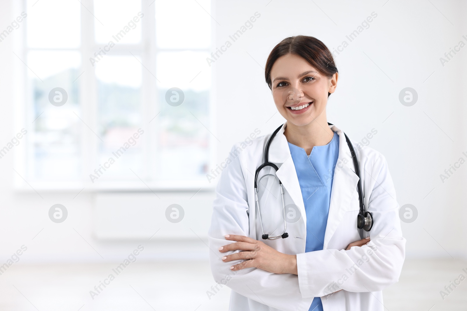 Photo of Smiling healthcare worker with stethoscope in hospital, space for text