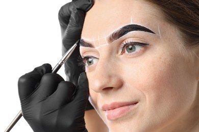 Photo of Young woman undergoing henna eyebrows dyeing procedure on light background, closeup