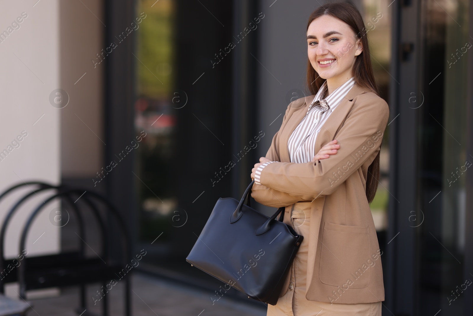 Photo of Beautiful woman in stylish suit outdoors. Space for text