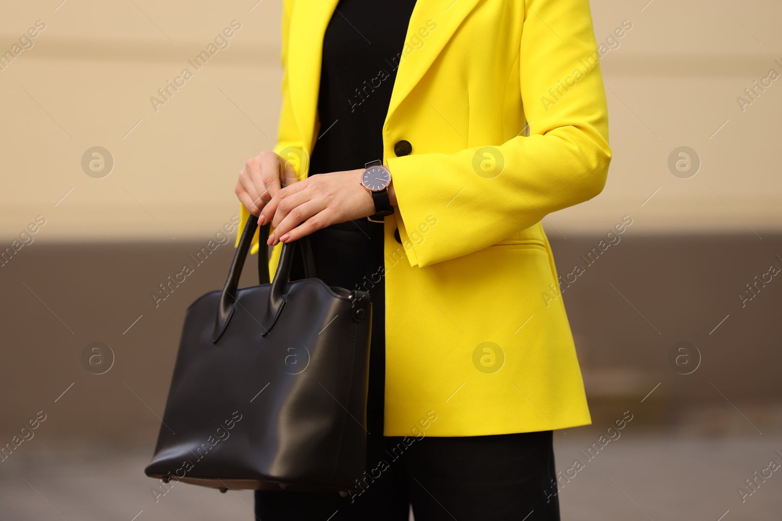 Photo of Businesswoman in stylish suit with bag outdoors, closeup