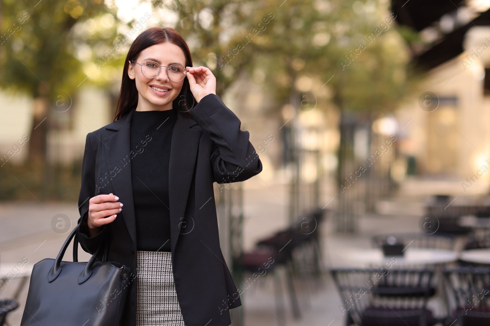 Photo of Beautiful woman in stylish suit outdoors. Space for text