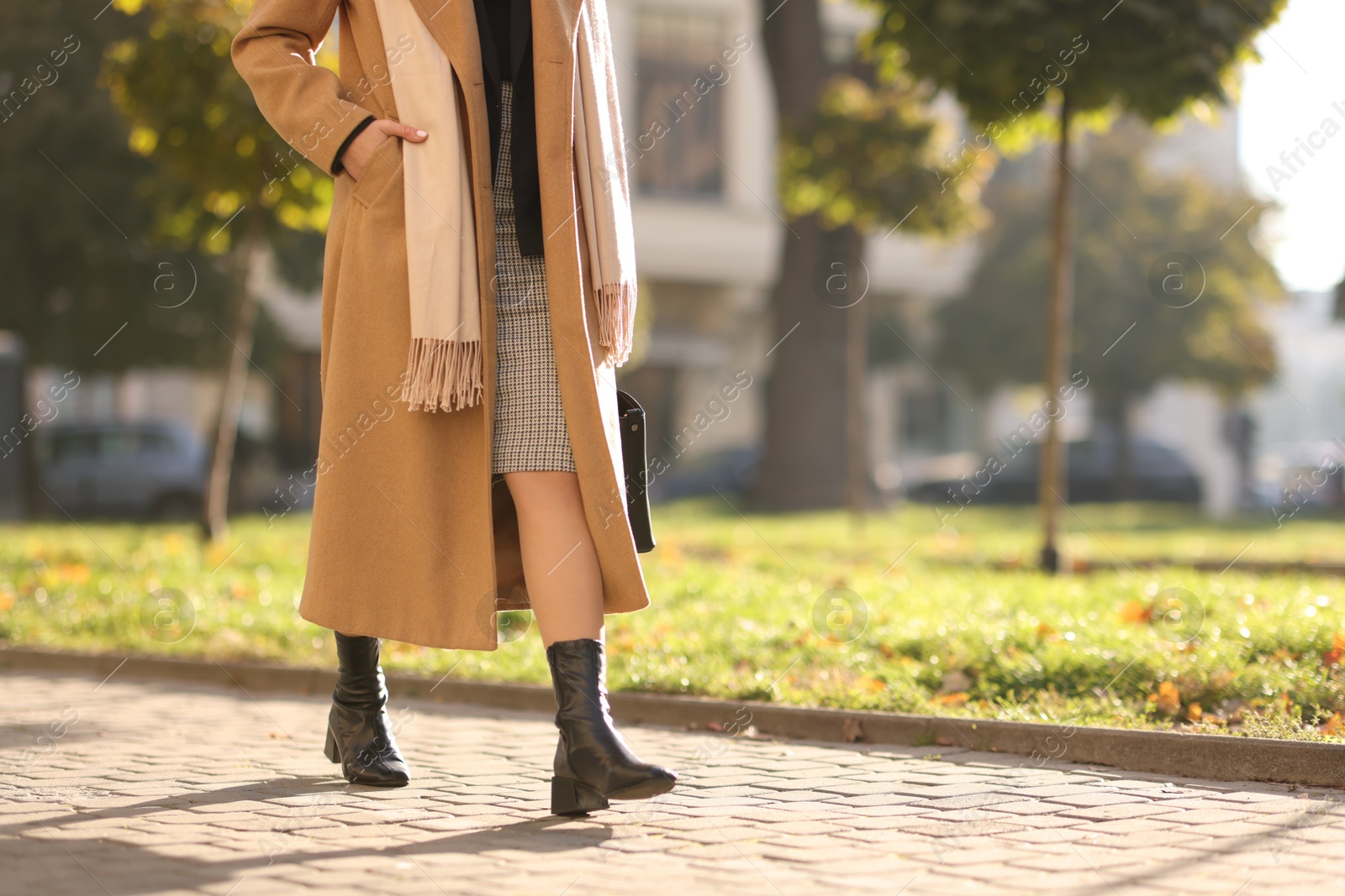 Photo of Businesswoman in stylish suit walking outdoors, closeup. Space for text