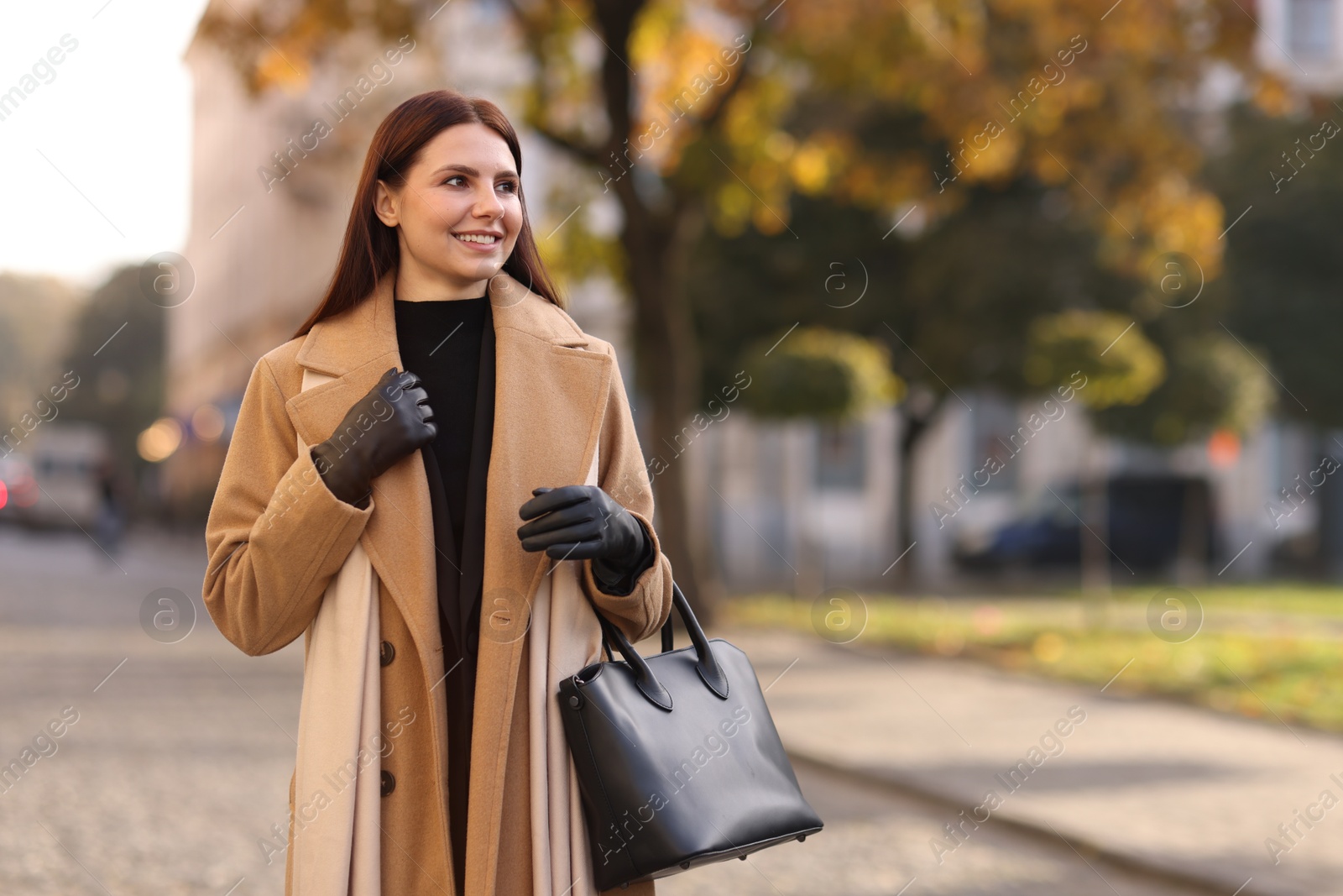 Photo of Beautiful woman in stylish suit outdoors. Space for text