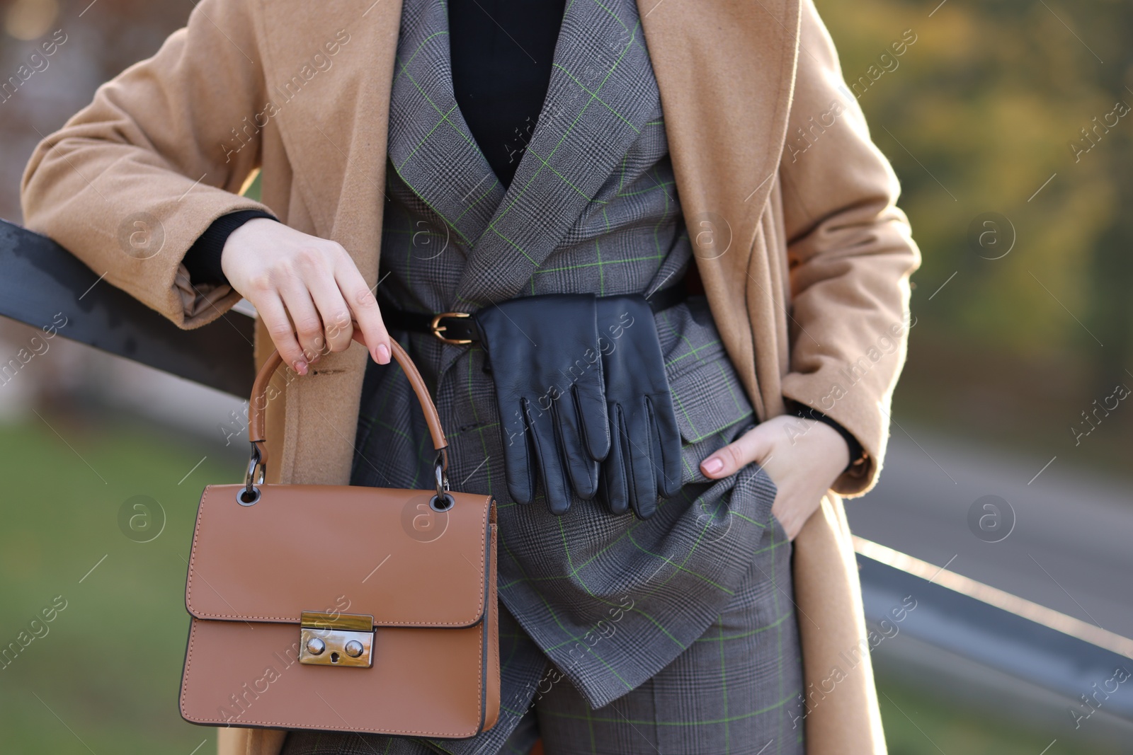 Photo of Businesswoman in stylish suit with bag outdoors, closeup view