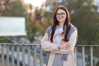 Beautiful woman in stylish suit outdoors. Space for text