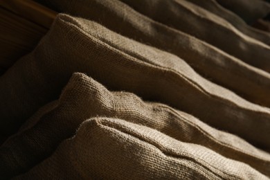 Photo of Closeup view of many natural burlap sacks