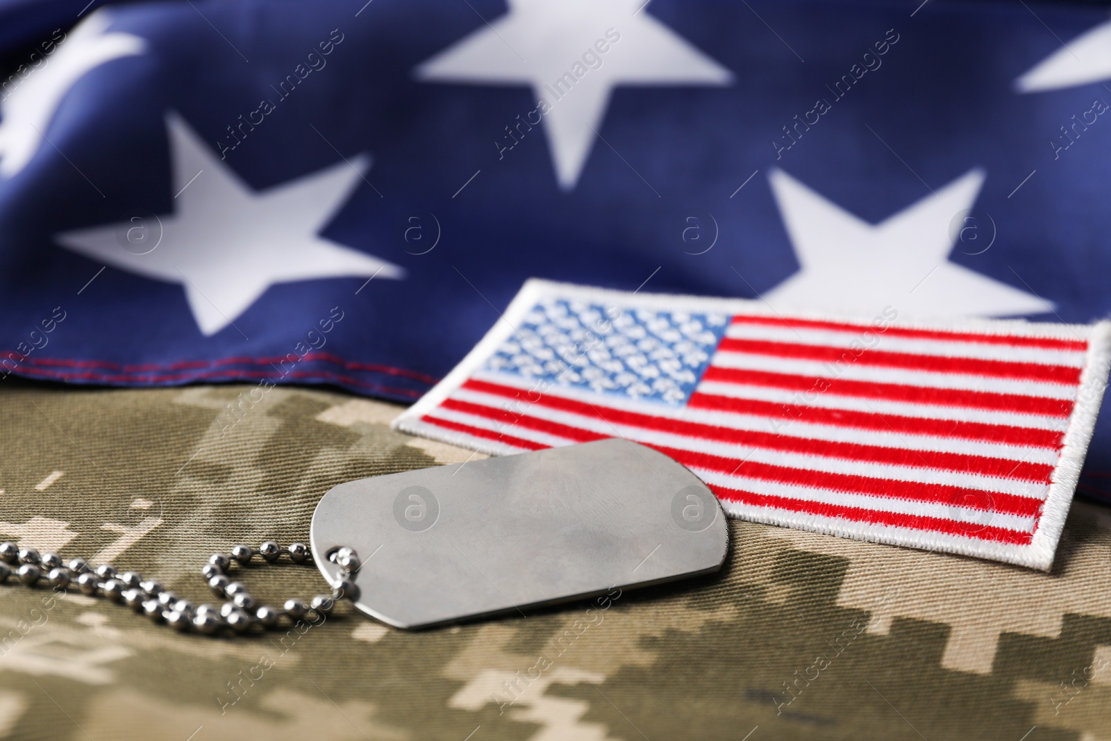 Photo of Veterans day. USA army patch, token, American flag and military uniform, closeup