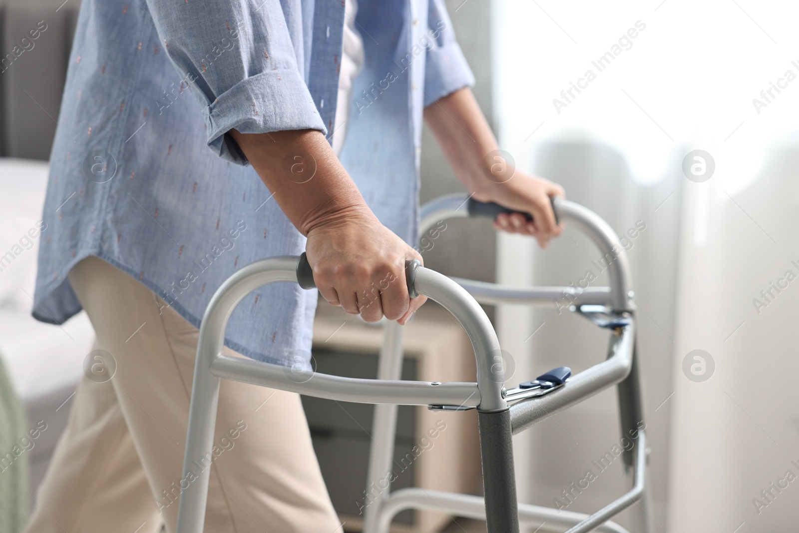 Photo of Senior woman with walking frame at home, closeup