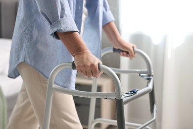 Photo of Senior woman with walking frame at home, closeup